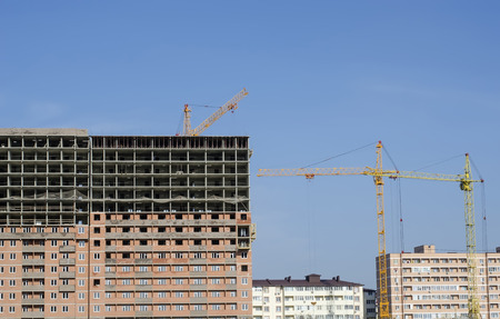 High-rise construction cranes against the background of the new buildings located the cascade.の写真素材