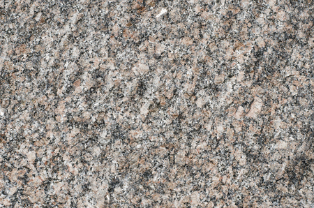 Background of coarse-grained crystal structure of pinkish-gray rock.の写真素材