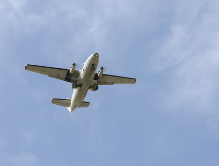 The flying gray liner not a background of the blue cloudy sky.の写真素材