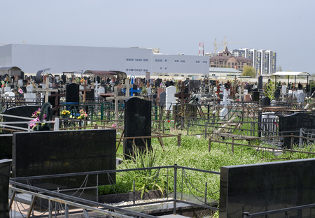 The city cemetery against the background of industrial buildings and houses.の写真素材