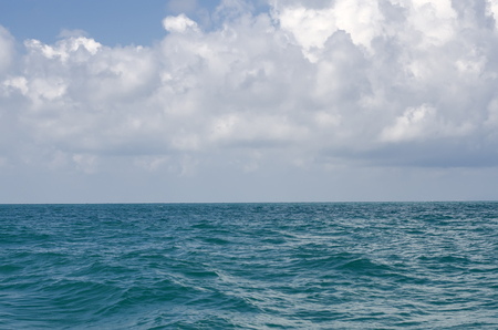 Seascape. Wavy sea surface and blue cloudy sky.の写真素材