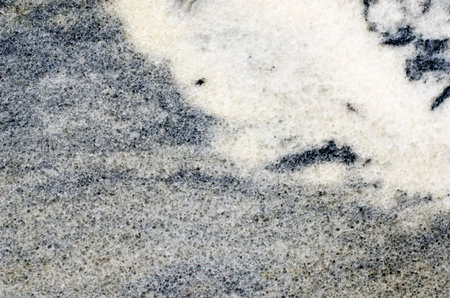 Marble background with granular and striate structure and white spots.