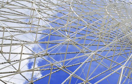 Openwork metal construction against the blue cloudy sky close upの写真素材