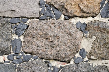 Closeup background of a stone slab from large acute-angle fragments of granite.の写真素材