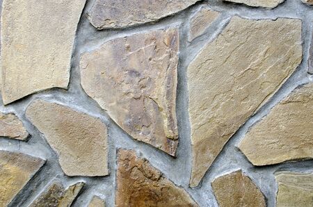 The structure of large fragments of brown sandstone in gray cement close-up.の写真素材