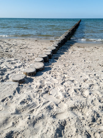 A groyne is a dam built in front of the sea, usually at right angles to the course of the beach, which serves to protect the coast.の写真素材