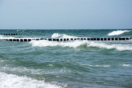 A groyne is a dam built in front of the sea, usually at right angles to the course of the beach, which serves to protect the coast.の写真素材