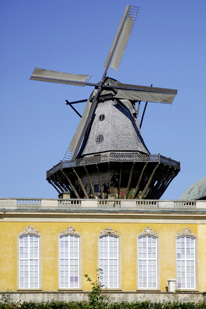 The New Chambers in the palace garden of Sanssouci in Potsdam with the historical windmill - Germany.のeditorial素材