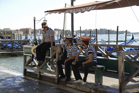 Three Gondoliers at the Grand Canal in Venice - Italy.のeditorial素材