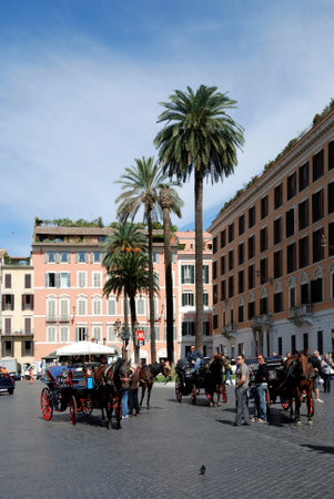 Horse coaches on the Piazza di Spagna at the Spanish steps in Rome - Italy.のeditorial素材