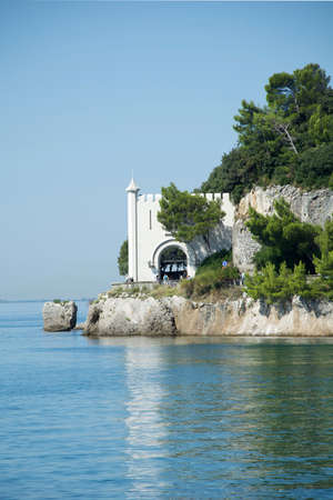 Entrance to Miramare Castle on a rocky cliff in the Bay of Grignano near Trieste - Italy.のeditorial素材