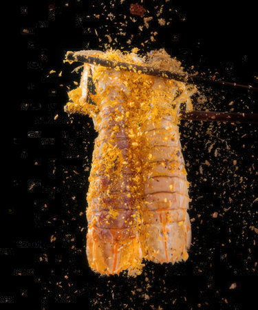 Sushi with chopsticks flying in the air on a black backgroundの写真素材