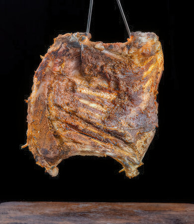 Smoked pork ribs isolated on a black background, studio shot.の写真素材