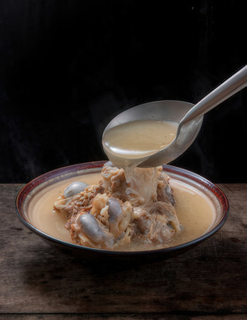 Soup in a bowl on wooden table.の写真素材