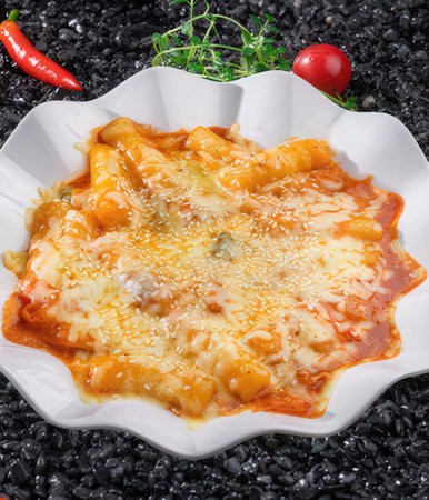 Ravioli with tomato sauce and cheese on a white plateの写真素材