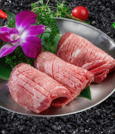 beef sirloin with herbs and spices on black stone backgroundの写真素材