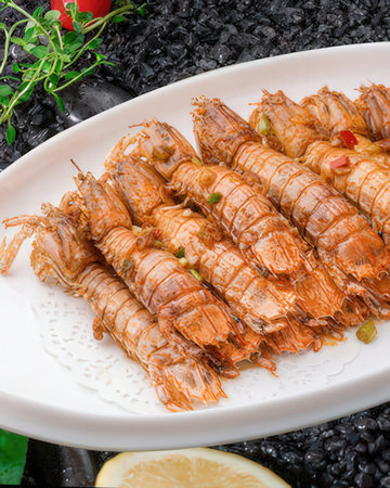 Seafood dish - Spicy shrimps on white plateの写真素材