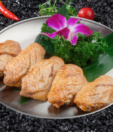 Japanese food, simmered chicken on a plate of black coalの写真素材