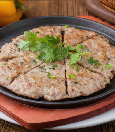 Grilled pork cutlets with parsley on a black plate.の写真素材