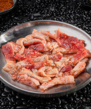 Sliced raw pork with soy sauce in bowlの写真素材