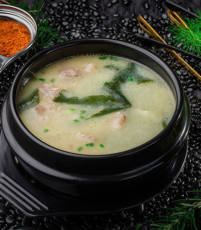 Creamy chicken soup in a bowl on a black background.の写真素材