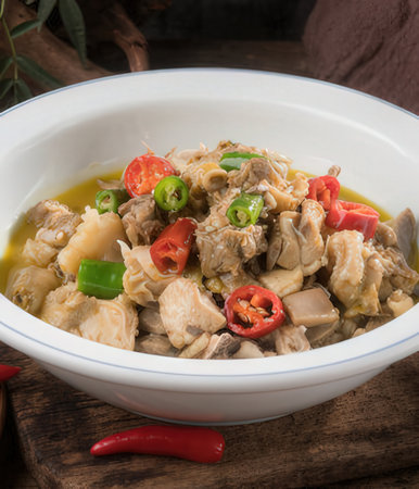Soup with chicken and vegetables in a white bowl on wooden backgroundの写真素材
