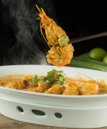 Thai Spicy Shrimp Curry on wooden table, Thailand.の写真素材