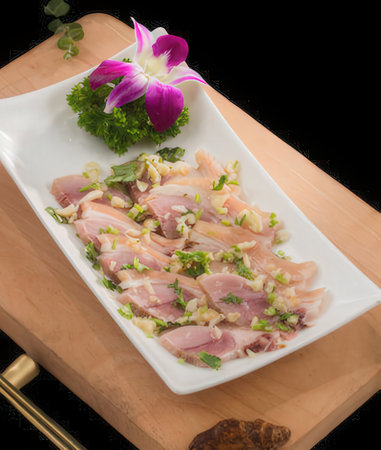 Raw chicken fillet with onion and parsley on a white plateの写真素材