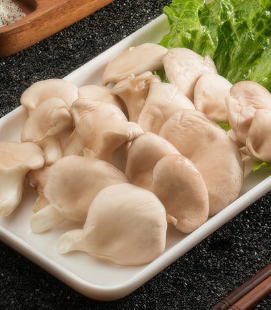 Japanese Shimeji mushrooms in a square bowl on a black backgroundの写真素材
