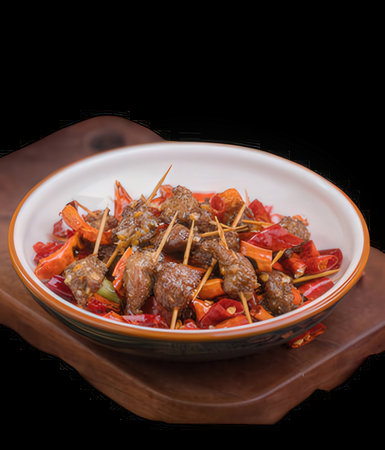 Chinese style stir fried meat with vegetables in a bowl on black backgroundの写真素材