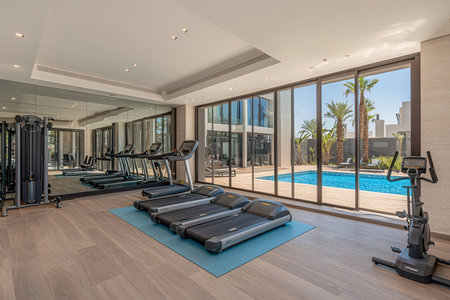 Interior of a modern fitness hall with a view of the poolの素材
