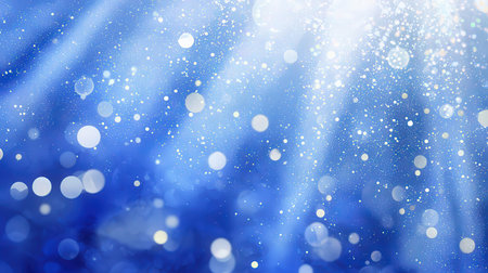 Abstract blue background with bokeh defocused lights and stars.の素材