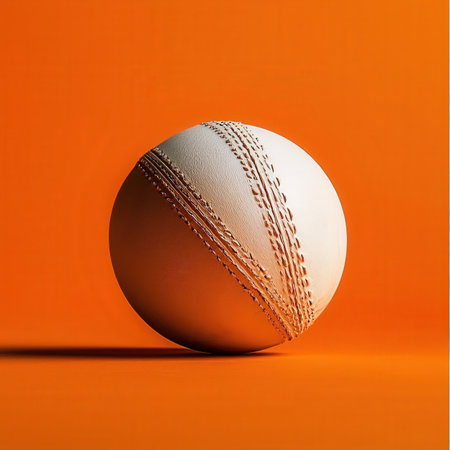 Cricket ball isolated on orange background. 3d illustration.の素材