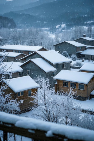 Houses in the mountains during a snowfall. Winter landscape.の素材