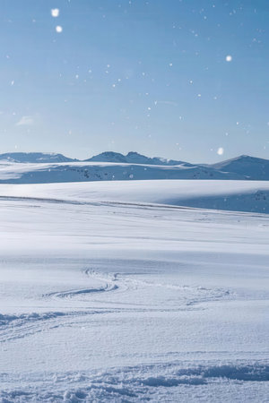 Beautiful winter landscape with snow covered mountains and blue sky in the backgroundの素材