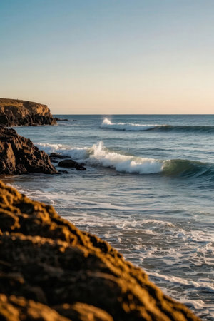 Beautiful seascape with waves crashing on the rocks at sunsetの素材