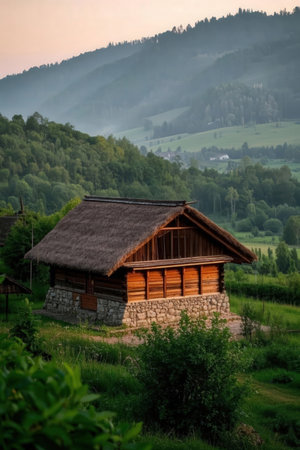 Wooden house in the mountains at sunrise. Beautiful landscape. Carpathians, Ukraine.の素材