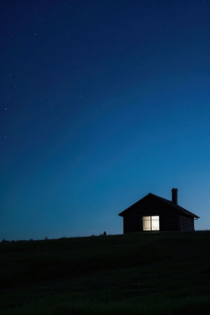 Old house in the field at night with stars in the sky.の素材