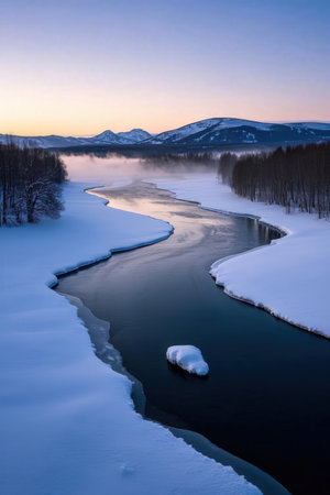 Beautiful winter landscape with frozen river in the mountains at sunset.の素材