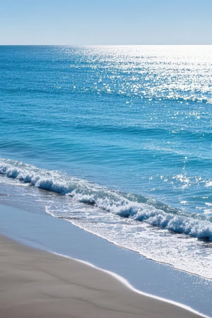 beautiful sandy beach on the background of the sea and blue skyの素材