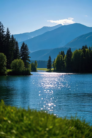 Landscape view of beautiful mountain lake with forest and blue sky.の素材