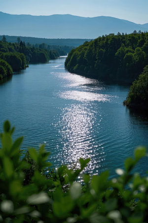 Beautiful landscape of the river and mountains in the evening light.の素材