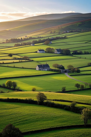 Idyllic English countryside landscape with green fields and rolling hills.の素材