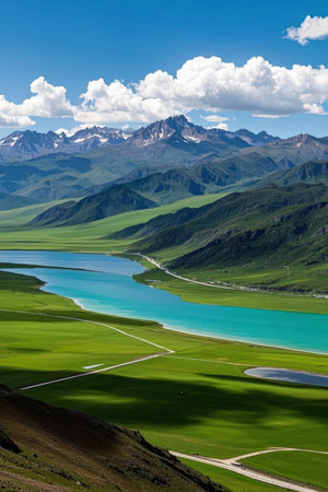 Beautiful view of green grassland and turquoise lake.の素材