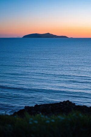 Sunset over the sea with a mountain in the background. Spainの素材