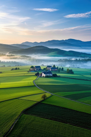 Aerial view of beautiful rural landscape with foggy village in the morningの素材