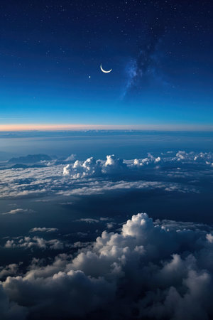 Moon and clouds in the night sky. View from airplane window.の素材