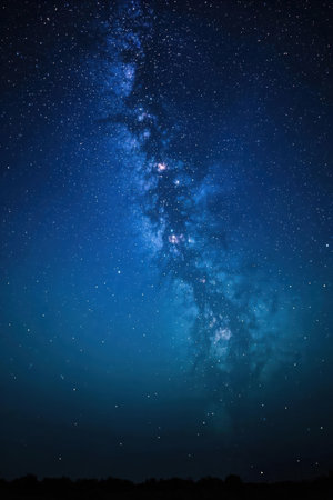 Milky Way in the night sky. Long exposure photograph with grainの素材