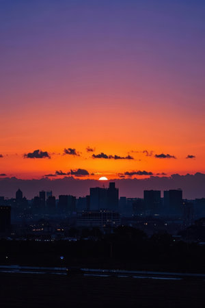 Sunset in the city with silhouette of buildings and skyscrapersの素材