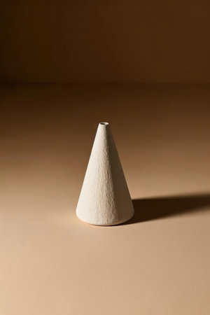 Ceramic cone on a beige background. Minimal style.の素材